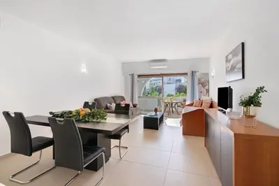 a living room with a bed and a kitchen at Apartament Dita in Albufeira