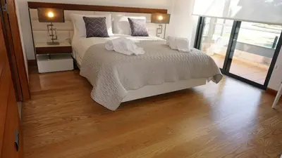 a bedroom with a bed with two towels on it at Luxury 3 Bedroom, 3 ensuits, Private pool, Vale do Lobo in Loulé
