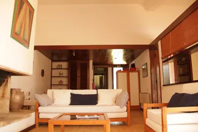 a living room with a white couch and a table at Apart. Barracuda in Vilamoura