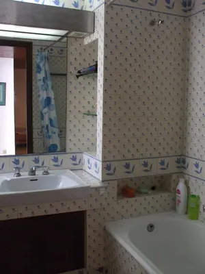 a bathroom with a sink and a mirror and a tub at Apart. Barracuda in Vilamoura