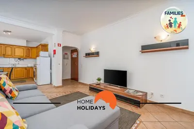 a living room with a couch and a tv at #290 Families Only - Choro Azul by Home Holidays in Albufeira