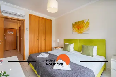 a bedroom with a bed with a home holidays sign on it at #284 Vista das Ondas by Home Holidays in Albufeira