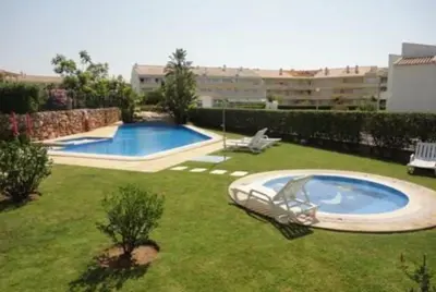 a yard with a swimming pool in a building at Vilamoura - Apartment near Mariana & Falesia Beach in Quarteira