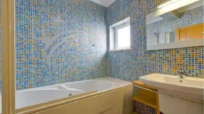 a blue tiled bathroom with a tub and a sink at Vilamoura - Apartment near Mariana & Falesia Beach in Quarteira