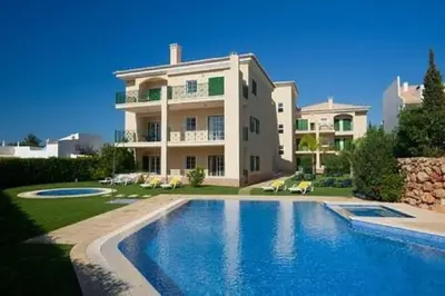 a large house with a swimming pool in front of it at Vilamoura - Apartment near Mariana & Falesia Beach in Quarteira