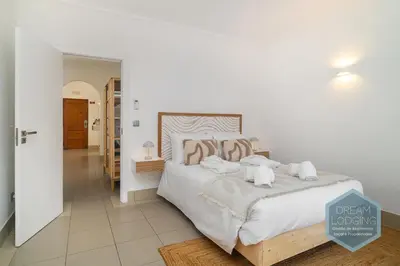 a bedroom with a large bed with white sheets and pillows at Casablanca - Dream Lodging in Albufeira