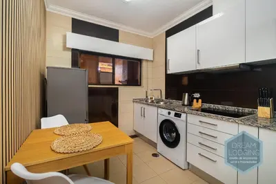 a kitchen with a table and a washing machine at Casablanca - Dream Lodging in Albufeira