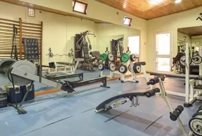 a gym with a lot of equipment in a room at Casablanca - Dream Lodging in Albufeira