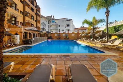 a swimming pool with lounge chairs and a hotel at Casablanca - Dream Lodging in Albufeira