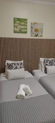 two beds sitting next to each other in a room at Oasis Apartment in Albufeira