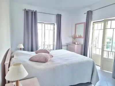 a bedroom with a white bed with two pillows on it at Mar à Vista Apartment in Albufeira