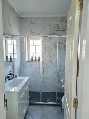 a bathroom with a shower and a sink at Mar à Vista Apartment in Albufeira