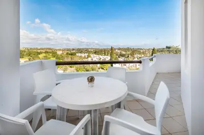 a bedroom with two beds and a door at Our House in Clube Albufeira in Albufeira
