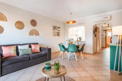 a living room with a table and chairs at Our House in Clube Albufeira in Albufeira