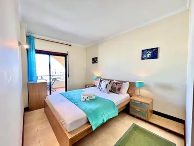 a bedroom with a large bed and a window at Albufeira Salgados Beach 6 by Homing in Albufeira