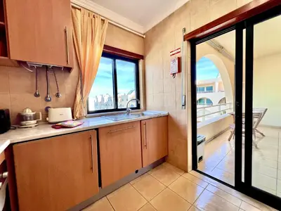 a kitchen with a sink and a window at Albufeira Salgados Beach 6 by Homing in Albufeira