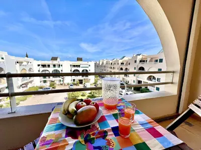 a plate of fruit on a table on a balcony at Albufeira Salgados Beach 6 by Homing in Albufeira