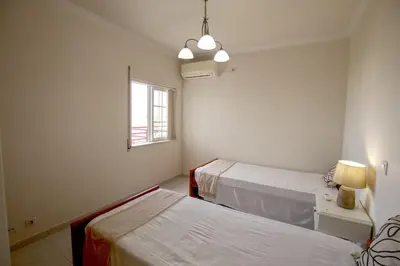 a hospital room with two beds and a window at Quarteira Apartment with views in Quarteira