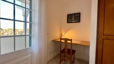 a desk with a lamp and a chair next to a window at Casa do Algarve by Check-in Portugal in Albufeira