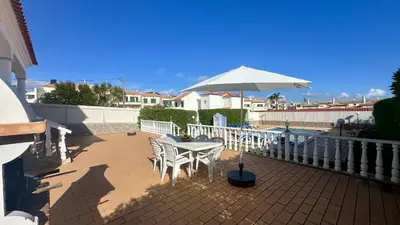 a table and chairs with an umbrella on a balcony at Casa do Algarve by Check-in Portugal in Albufeira