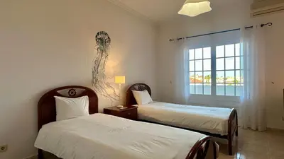 a hotel room with two beds and a window at Casa do Algarve by Check-in Portugal in Albufeira