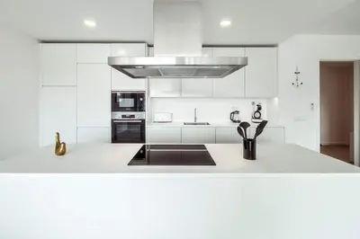 a white kitchen with a sink and a stove at Albufeira Green Dream Pool, Balcony & BBQ in Albufeira