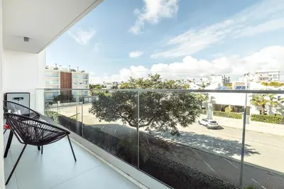 a balcony with a chair and a view of a street at Albufeira Green Dream Pool, Balcony & BBQ in Albufeira