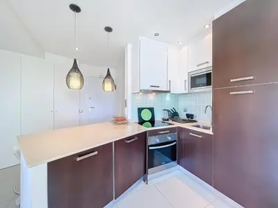 a kitchen with white and brown cabinets and appliances at Paradise Near Old Town in Albufeira