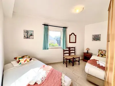 a bedroom with two beds and a window at Vilamoura Classic 2 with Pool by Homing in Quarteira