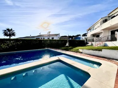 a swimming pool in front of a building at Vilamoura Classic 2 with Pool by Homing in Quarteira