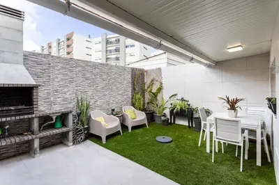 a patio with chairs and tables and a fireplace at Casa dos Avós - Faro Relax & Comfort in Faro