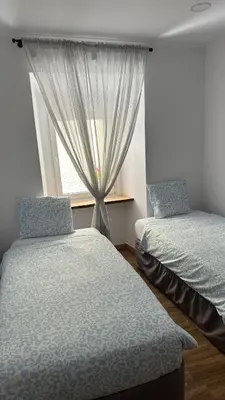 two beds in a room with a window at Sweet Dreams in Albufeira