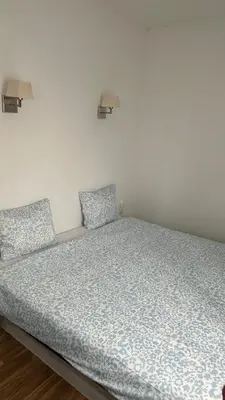 a bed in a white room with two pillows at Sweet Dreams in Albufeira