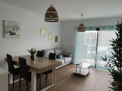 a living room with a table and a couch at Appartement T1 Faro in Faro