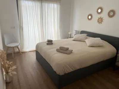 a bedroom with a large bed with towels on it at Appartement T1 Faro in Faro