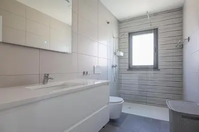 a white bathroom with a sink and a toilet at Villa Soares - Centro Albufeira - For Families - BY BEDZY in Albufeira