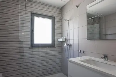a bathroom with a shower and a sink and a mirror at Villa Soares - Centro Albufeira - For Families - BY BEDZY in Albufeira