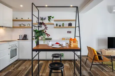 a small kitchen with a table and chairs at Roots Apartments in Faro