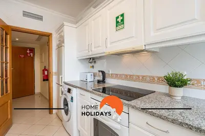 a kitchen with a washer and dryer at #271 T2 Bicos Flat U by Home Holidays in Albufeira