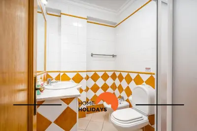 a bathroom with a toilet and a sink at #271 T2 Bicos Flat U by Home Holidays in Albufeira