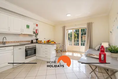 a large swimming pool with a sign that says have holidays at #272 T2 Bicos Flat J by Home Holidays in Albufeira