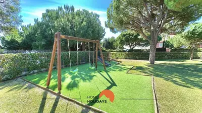 a swing set in a yard with a tree at #272 T2 Bicos Flat J by Home Holidays in Albufeira