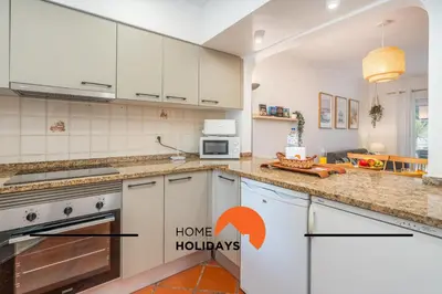 a kitchen with white cabinets and a stove top oven at #250 Apartamento 264 by Home Holidays in Albufeira