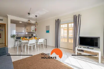 a kitchen and living room with a tv and a table at #274 T3 Bicos T by Home Holidays in Albufeira