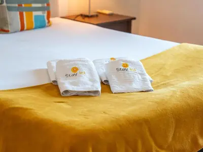 two towels sitting on top of a bed at Sunshine House by Stay ici Algarve Holiday Rental in Albufeira