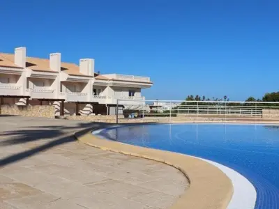 a swimming pool in front of a large building at Sunshine House by Stay ici Algarve Holiday Rental in Albufeira