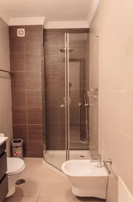 a bathroom with a shower and a toilet and a sink at Sea Blue - Frente ao Mar in Quarteira