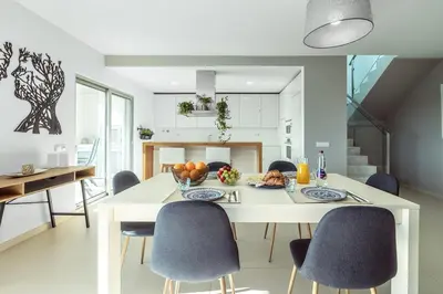 two chairs sitting on the balcony of a house at Penthouse Isabela VistaMar - Rooftop & Jacuzzi in Albufeira