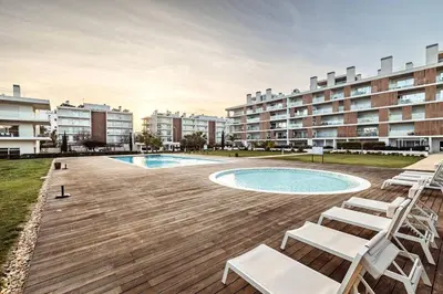 a living room with a table and a dining room at Penthouse Isabela VistaMar - Rooftop & Jacuzzi in Albufeira