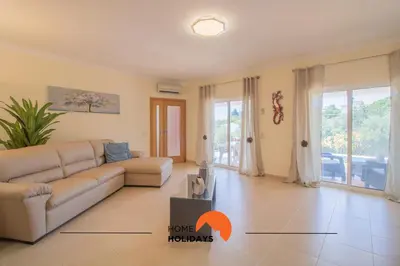 a living room with a couch and a table at #297 Espaçosa Vivenda V5 by Home Holidays in Albufeira